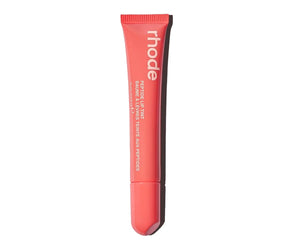 R. Beauty Peptide Lip Tint in Peach Pit, showing a natural peach-colored lip makeup product in a sleek tube.