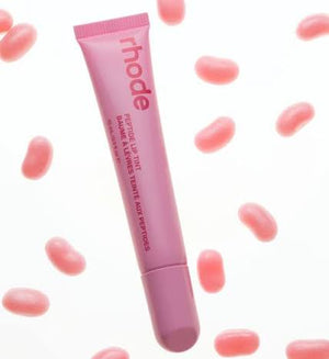 R. Beauty Peptide Lip Tint in Jelly Bean, vibrant pink makeup product applied on lips with a glossy finish.