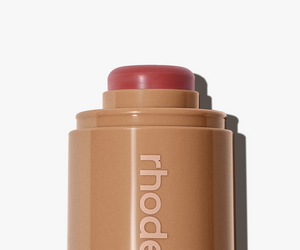 Rhode Skin Pocket Blush in Sleepy Girl, a makeup compact with soft pink blush visible on a beige background.