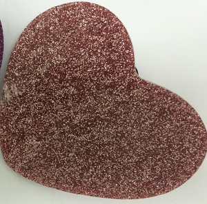 Pink glitter heart makeup product by Paw Palette with shimmering pink glitter and heart shape design.