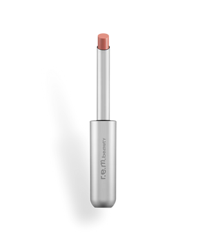 r.e.m beauty Kiss Me lipstick in a sleek tube, featuring a vibrant lipstick shade ready for makeup application.