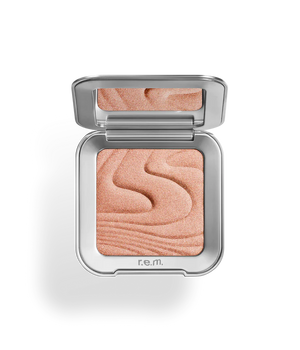 r.e.m beauty Saturn Highlighter for makeup, showing the shimmering powder with a compact case and reflective surface.