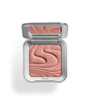 r.e.m beauty Uranus highlighter makeup with shimmery, luminous finish and sleek packaging.